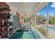 This screened patio is decorated with cozy seating and a fun, colorful rug at 7424 Acorn Blvd, Punta Gorda, FL 33982