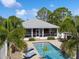 Aerial view featuring a gorgeous pool and screened in porch, perfect for relaxing and entertaining at 7424 Acorn Blvd, Punta Gorda, FL 33982