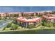Beautiful waterfront condos with red roofs, mature landscaping, and a tennis court at 90 Vivante Blvd # 202, Punta Gorda, FL 33950