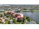 Expansive aerial shot showcases condos nestled beside tranquil water, offering a scenic living experience at 90 Vivante Blvd # 202, Punta Gorda, FL 33950