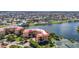 A picturesque aerial view of a condo community with waterways, tennis courts and red-tiled roofs at 90 Vivante Blvd # 202, Punta Gorda, FL 33950