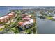 Beautiful aerial shot showcasing condos with stunning red roofs, near a lake and a beautiful neighborhood at 90 Vivante Blvd # 202, Punta Gorda, FL 33950