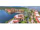 Condos on a waterfront featuring red roofs, tennis courts, a pool and lush landscaping at 90 Vivante Blvd # 202, Punta Gorda, FL 33950