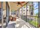 Screened-in balcony with seating area and palm tree views at 90 Vivante Blvd # 202, Punta Gorda, FL 33950