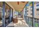Screened-in balcony with seating area and palm tree views at 90 Vivante Blvd # 202, Punta Gorda, FL 33950