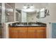 Elegant bathroom showcasing double sinks with granite countertops, a tiled shower, and ample storage space at 90 Vivante Blvd # 202, Punta Gorda, FL 33950