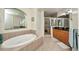 Well-appointed bathroom featuring a large soaking tub, separate shower, and elegant fixtures, offering a spa-like experience at 90 Vivante Blvd # 202, Punta Gorda, FL 33950