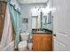 Traditional bathroom featuring tile walls, granite counter and shower/tub with curtain at 90 Vivante Blvd # 202, Punta Gorda, FL 33950