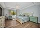 Inviting bedroom with a serene ambiance, featuring a large window, cozy chair, and well-placed bedside tables at 90 Vivante Blvd # 202, Punta Gorda, FL 33950