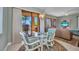 Cozy dining area featuring a glass-top table with three seats, blending comfort and style with a beautiful view at 90 Vivante Blvd # 202, Punta Gorda, FL 33950