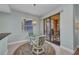 Cozy dining area with a glass table and access to an outdoor patio, perfect for entertaining at 90 Vivante Blvd # 202, Punta Gorda, FL 33950