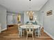 Bright dining room with an elegant chandelier and seating for four around a round table at 90 Vivante Blvd # 202, Punta Gorda, FL 33950