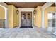 Inviting entryway featuring double doors with arched glass, framed by stone and sconces, alongside an elevator at 90 Vivante Blvd # 202, Punta Gorda, FL 33950