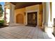 Inviting entrance with detailed pillars and beautiful wood framed doors with arched window at top at 90 Vivante Blvd # 202, Punta Gorda, FL 33950