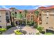 Beautiful view of the building with manicured lawns and landscaping at 90 Vivante Blvd # 202, Punta Gorda, FL 33950