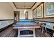 Entertaining game room with a beautiful pool table, bar-style seating, and elegant decor at 90 Vivante Blvd # 202, Punta Gorda, FL 33950