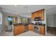 Bright open kitchen features stainless steel appliances and views through large windows to the patio at 90 Vivante Blvd # 202, Punta Gorda, FL 33950