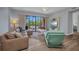 Bright living room featuring wood floors, a ceiling fan, and access to a private balcony at 90 Vivante Blvd # 202, Punta Gorda, FL 33950