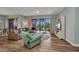 Comfortable living room with wood floors, slider doors, and a picturesque outdoor view at 90 Vivante Blvd # 202, Punta Gorda, FL 33950