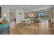 Open-concept living space with wood floors, dining area, and a balcony overlooking a tranquil view at 90 Vivante Blvd # 202, Punta Gorda, FL 33950