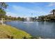 Scenic pond with a central fountain, surrounded by lush greenery and community buildings, enhancing the property's serene atmosphere at 90 Vivante Blvd # 202, Punta Gorda, FL 33950