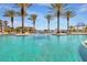 Sparkling swimming pool with lounge chairs and palm trees at 90 Vivante Blvd # 202, Punta Gorda, FL 33950