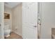 Toilet room with tiled floor and closed door that leads to a bedroom at 90 Vivante Blvd # 202, Punta Gorda, FL 33950