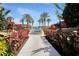 Beautifully landscaped walkway with palm trees leading to the water and pool at 90 Vivante Blvd # 202, Punta Gorda, FL 33950