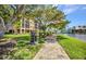 Community walkway with a grill, bench, manicured lawns and views of the water, offering a serene outdoor experience at 90 Vivante Blvd # 202, Punta Gorda, FL 33950