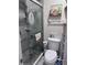 Compact bathroom showcasing a modern glass-enclosed shower, complemented by stylish storage and fixtures at 93 Boundary Blvd # 303, Rotonda West, FL 33947