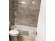 Bathroom with neutral ceramic tiling around tub and shower at 93 Boundary Blvd # 303, Rotonda West, FL 33947