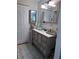 Well-organized bathroom featuring a stylish vanity with storage baskets, complemented by ample mirror space at 93 Boundary Blvd # 303, Rotonda West, FL 33947