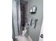 Stylish bathroom featuring a tiled shower with a patterned curtain, enhanced by decorative shelving and soft towels at 93 Boundary Blvd # 303, Rotonda West, FL 33947