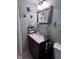 Well-decorated bathroom with marine life accents, highlighting a vanity with marble top and decorative storage at 93 Boundary Blvd # 303, Rotonda West, FL 33947