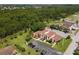 Exterior aerial view of the condos, parking, landscaping and surrounding green space at 93 Boundary Blvd # 303, Rotonda West, FL 33947