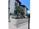 Condo exterior features a beautiful garden area, lovely landscaping and a small palm tree at 93 Boundary Blvd # 303, Rotonda West, FL 33947