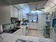 Bright kitchen features all white cabinets and appliances, with tiled floor at 93 Boundary Blvd # 303, Rotonda West, FL 33947