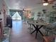 Open-concept living room with a dining area, tile flooring, and natural light at 93 Boundary Blvd # 303, Rotonda West, FL 33947