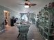 Spacious living room with tile flooring, ceiling fans, and views of a patio at 93 Boundary Blvd # 303, Rotonda West, FL 33947