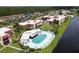 Aerial shot of the community pool, condos, parking and landscaping at 93 Boundary Blvd # 303, Rotonda West, FL 33947