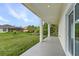 View of covered back porch overlooking spacious yard and lush greenery, offering serene outdoor living at 165 Ingram Blvd, Rotonda West, FL 33947