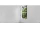 Bright, white room with a window showcasing lush greenery and a clear blue sky, creating a peaceful atmosphere at 165 Ingram Blvd, Rotonda West, FL 33947