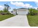 Charming single-Gathering home with a lush green lawn, modern design, and a two-car garage at 165 Ingram Blvd, Rotonda West, FL 33947