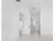 Bright hallway with white walls, marble flooring, and open doorways leading to other rooms in the home at 165 Ingram Blvd, Rotonda West, FL 33947