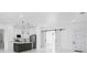 Bright, open floor plan with a kitchen island and sliding barn doors, ideal for modern living at 165 Ingram Blvd, Rotonda West, FL 33947