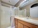 Bathroom featuring a glass door shower, light counter, and ample mirror at 1273 Jonah Dr, North Port, FL 34289