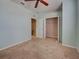Bedroom with light blue walls and carpet floors, featuring a closet and stairwell access at 1273 Jonah Dr, North Port, FL 34289