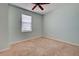 A light and airy bedroom with carpet floors, window, and a ceiling fan at 1273 Jonah Dr, North Port, FL 34289