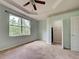 A tranquil bedroom with a large window, closet, and neutral carpet flooring at 1273 Jonah Dr, North Port, FL 34289