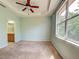 Bedroom featuring ensuite bathroom, neutral walls, plush carpet, and a ceiling fan at 1273 Jonah Dr, North Port, FL 34289